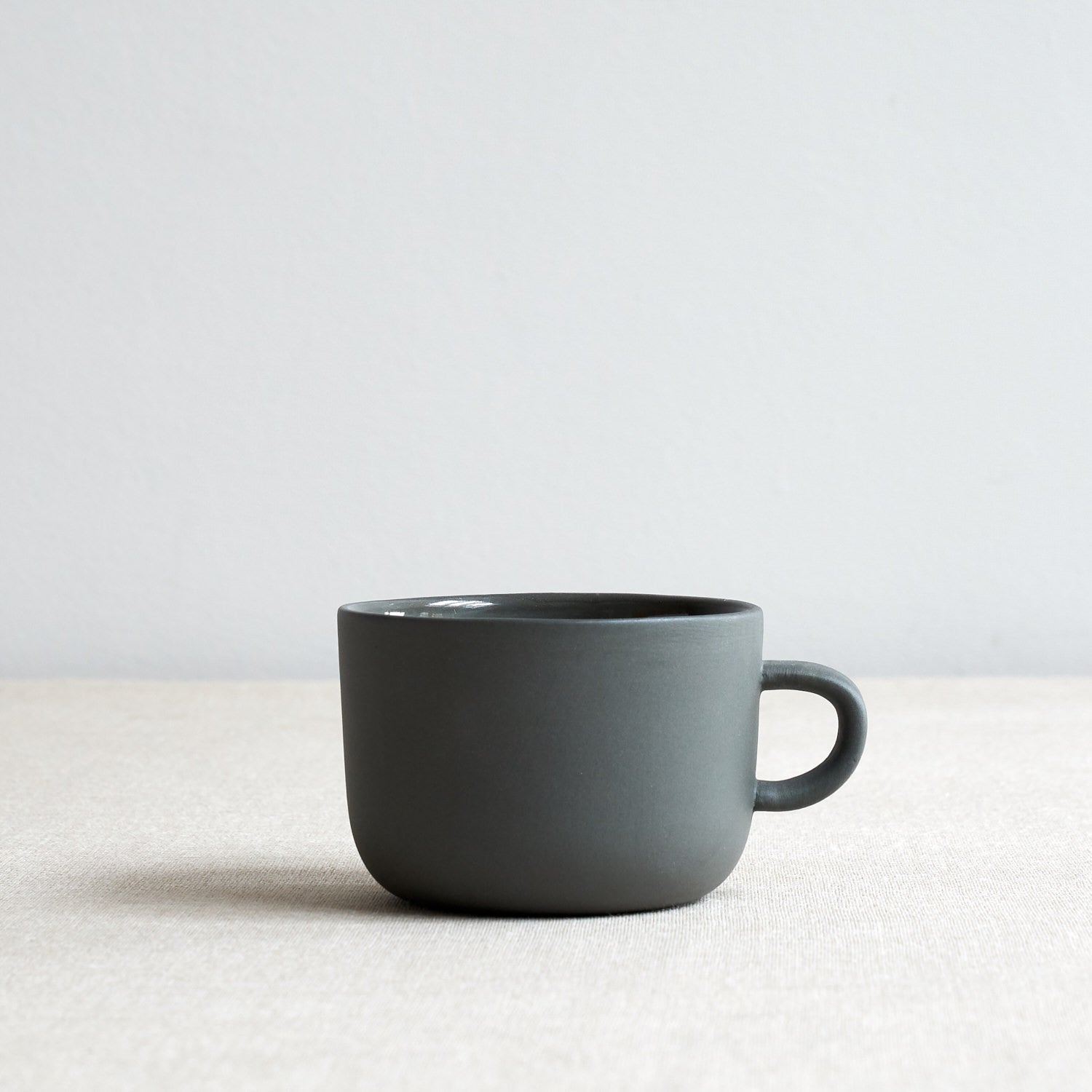 Sue Pryke tea cup in charcoal colour